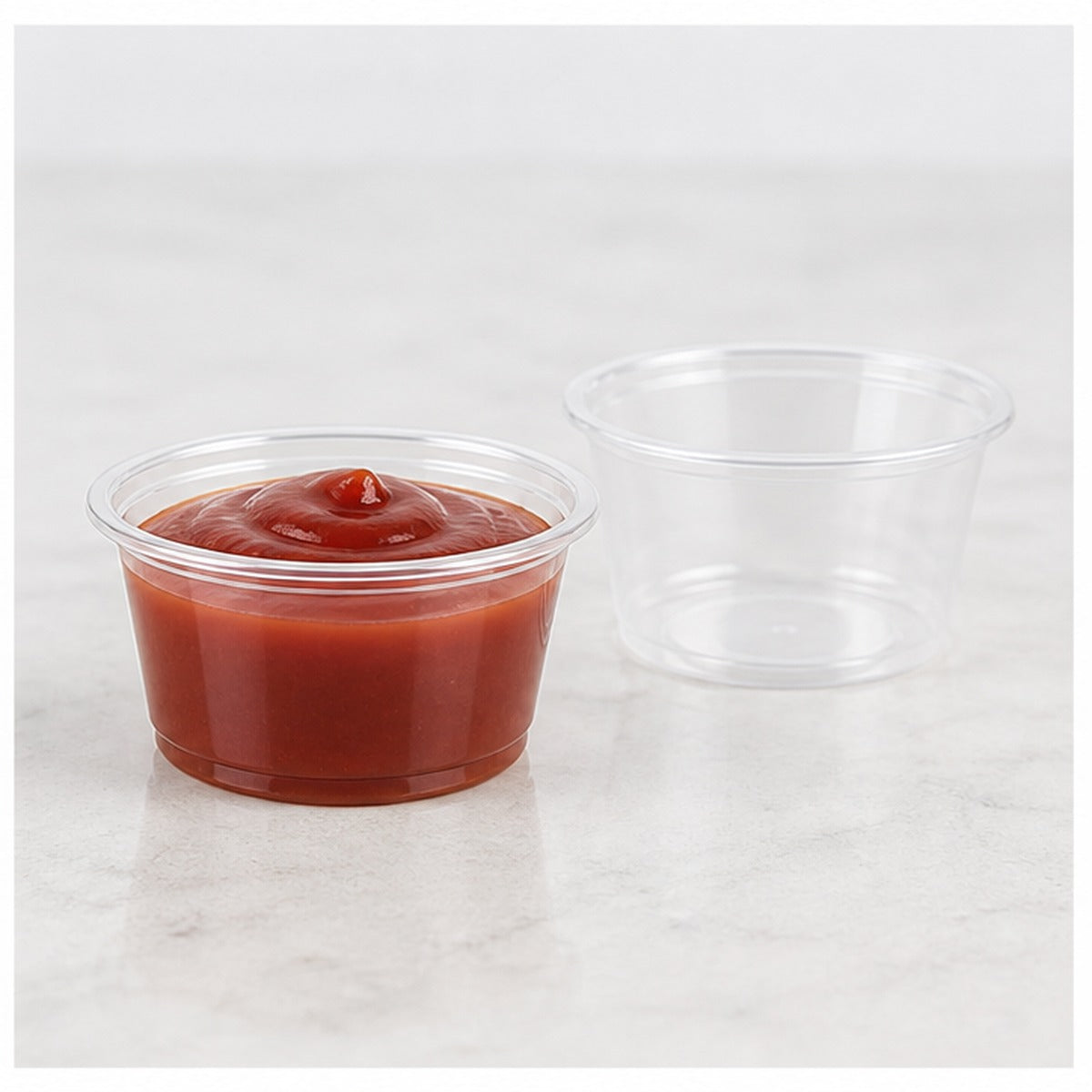 1.5 oz clear plastic portion cup filled with sauce - 2,500/Case