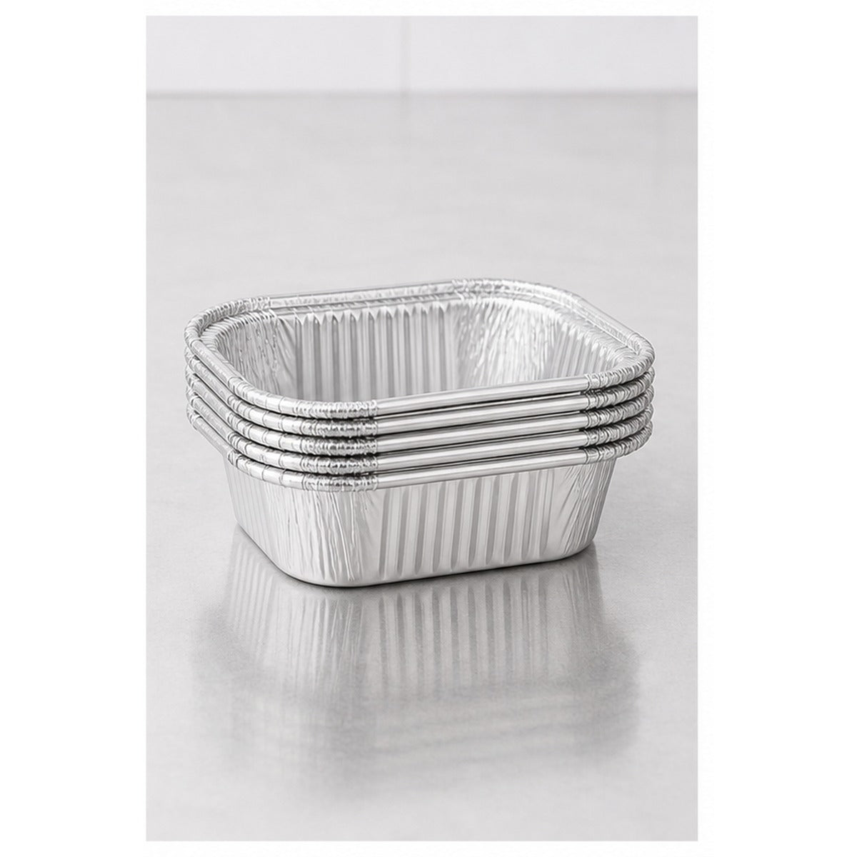 Stack of 1 lb oblong foil take-out containers - 1,000/Case